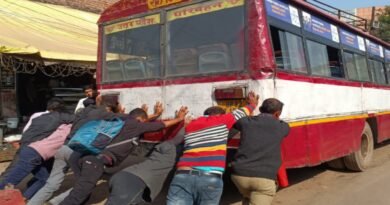 Passengers push the dilapidated buses of Rath depot.